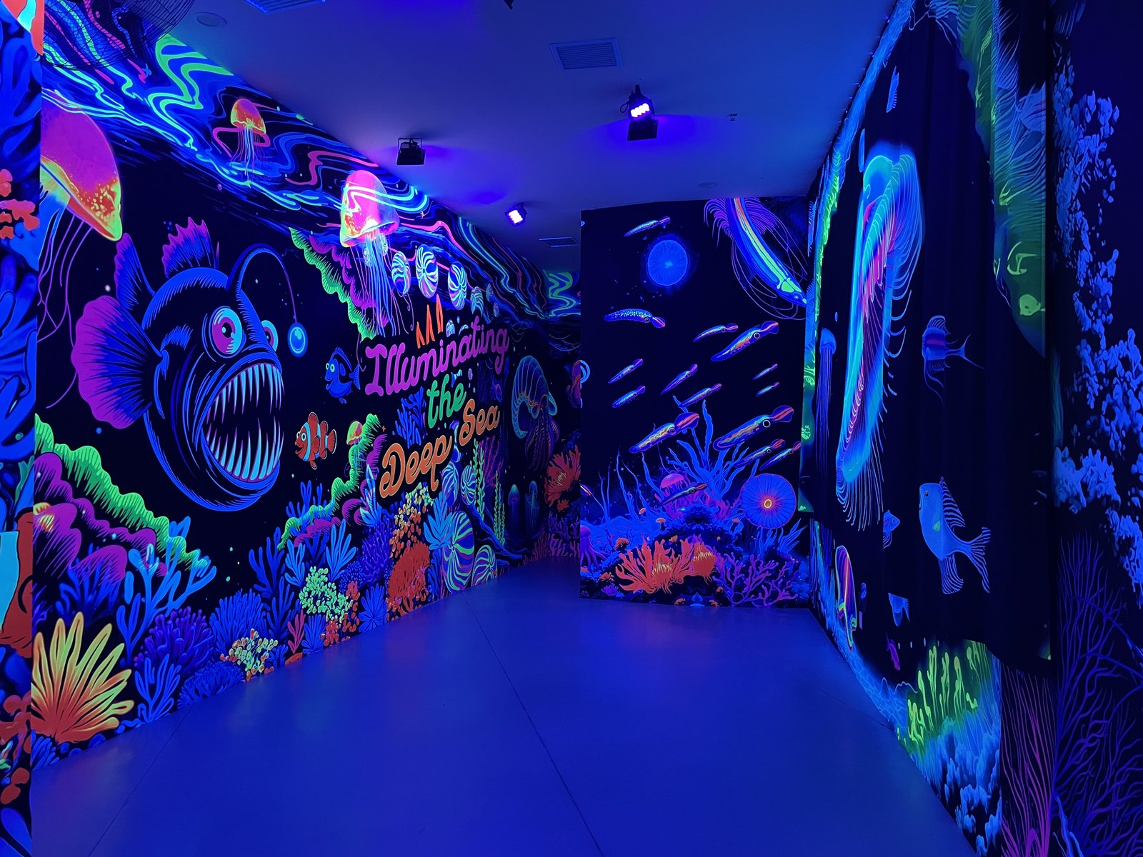 UV-reactive game room with glowing wall graphics